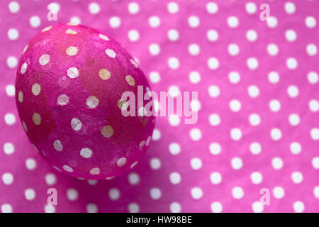 Close-up of pink  Easter egg with decoration on table Stock Photo