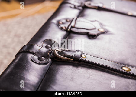 Black vintage suitcase leather texture. Old style bag clasp, buckle and belt closeup Stock Photo