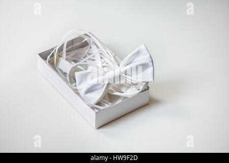 Luxury silk bow-tie in decorated box on light background Stock Photo