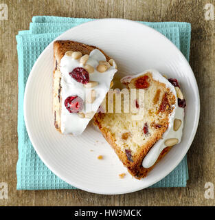 two pieces of fruit cake with nuts on white plate, top view Stock Photo