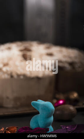 Easter bunny, eggs and cake, over a dark rusty tray Stock Photo