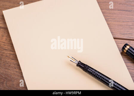 Fountain pen pad paper letter. Blank paper and pen shot from overhead. Stock Photo
