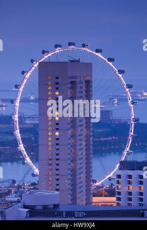 Singapore, Singapore Flyer, giant ferris wheel, elevated view with Ritz Carlton Hotel, dawn