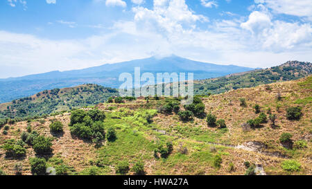 travel to Italy - view of Etna mount and green mountain slope near Calatabiano town in Sicily Stock Photo