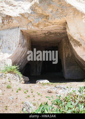 travel to Italy - entrance to Grotta dei Cordari (Rope-makers Cave) in Temenites Hill in Latomie del Paradiso area of Archaeological Park of Syracuse  Stock Photo