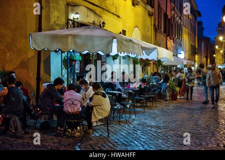 Italy, Lazio, Rome, historical centre listed as World Heritage by UNESCO, district of Trastevere, consumers sat at the table in the terrace of a bar d Stock Photo