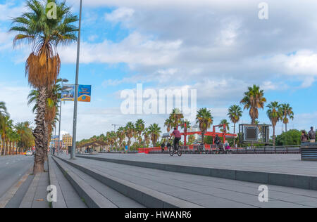 Barcelona, Spain, Nov 3rd, 2013: Tourism economy - Urban outdoors, people take advantage of warm weather.  Walking, running, bicycling & exercising. Stock Photo