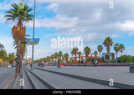 Barcelona, Spain, Nov 3rd, 2013: Tourism economy - Urban outdoors, people take advantage of warm weather.  Walking, running, bicycling & exercising. Stock Photo