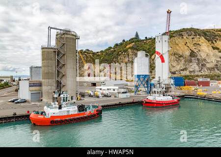 Tugs moored at the Port of Napier with silos in the background, New Zealand, Stock Photo