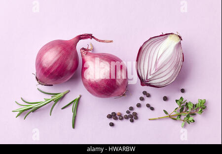 red onions and spices on purple background, top view Stock Photo