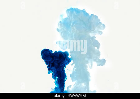 Multicolored swirling drop of ink in water creates abstract backgrounds Stock Photo