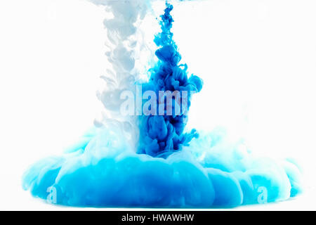 Multicolored swirling drop of ink in water creates abstract backgrounds Stock Photo