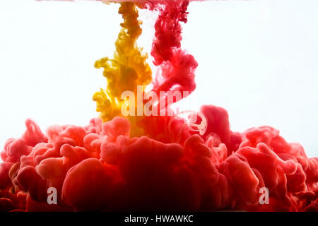 Multicolored swirling drop of ink in water creates abstract backgrounds Stock Photo