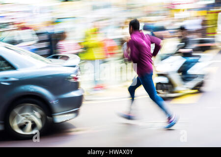 street scene with car and running man in motion blur Stock Photo