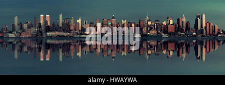 Midtown Manhattan skyline with reflections at dusk panorama over Hudson River Stock Photo
