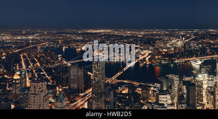 Rooftop night view of New York City downtown with urban skyscrapers ...