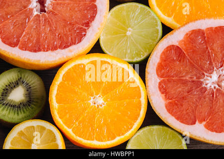 Slices fresh fruits on a wooden table Stock Photo
