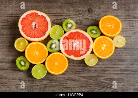 Slices fresh fruits on a wooden table Stock Photo