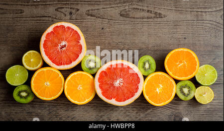 Slices fresh fruits on a wooden table Stock Photo