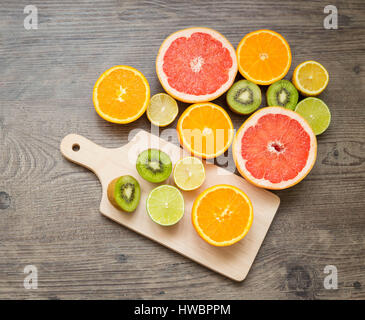 Slices fresh fruits on a wooden table Stock Photo