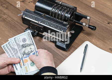 Hands of person counting the dollars at the table. Horizontal indoors shot Stock Photo