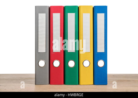 Multi-colored stationery folder for documents on a wooden table isolated on white background Stock Photo