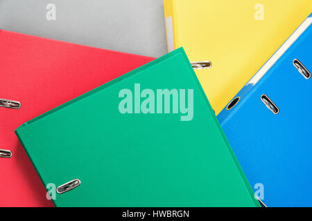Stationery office multicolored folders randomly stacked on one another, as a background Stock Photo