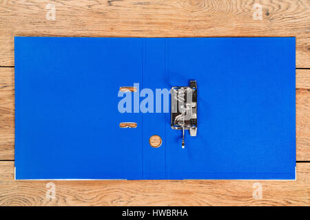 Open empty blue folder for storage of documents lying on a wooden table Stock Photo