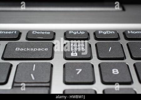 Modern laptop keyboard closeup. Backspace and num lock keys. Shallow depth of field. Stock Photo