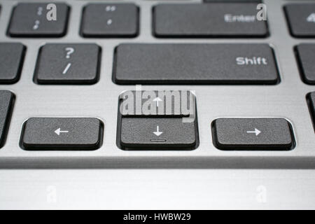Modern laptop keyboard closeup. Arrow keys.  Shallow depth of field. Stock Photo
