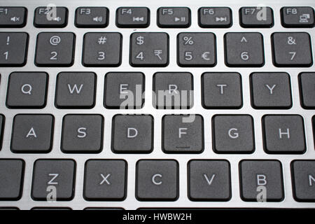 Modern laptop QWERTY keyboard closeup. Shallow depth of field. Stock Photo