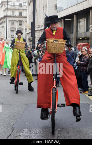 man on a giant bicycle wearing stilts Stock Photo