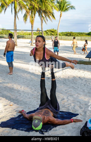 Miami Beach Florida,Ocean Drive,Lummus Park,Calisthenics Public Gym,outdoor,sand,fitness,exercise,acrobatics,yoga,acroyoga,plank,balancing,Hispanic La Stock Photo