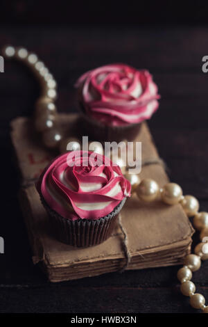 Pink roses cupcakes on the table,selective focus Stock Photo