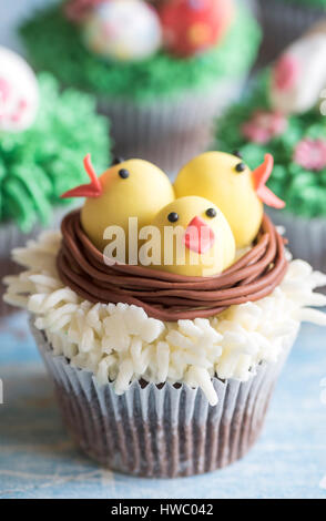 Chickens in the nest on Easter cup cake,selective focus Stock Photo