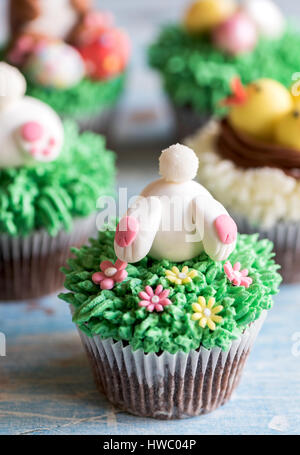Easter bunny in grass on the top of cup cake,selective focus Stock Photo