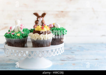 Served Easter cup cakes on wooden background with blank space,selective focus Stock Photo