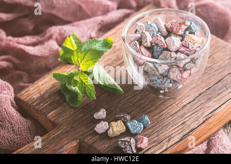 Multicolor bonbon sweets stone candies in glass bowl on wooden background Stock Photo
