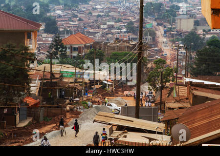 An overlook of Makerere, one of the northern parishes of Kampala city. In Luganda, the original local language of the Kampala region, Kampala means the city on seven hills. But as an effect of the huge population growth, many people are forced to live in the wetlands between the hills. Many of the wetland-areas are slums, but this one is just a regular area of Kampala. Stock Photo
