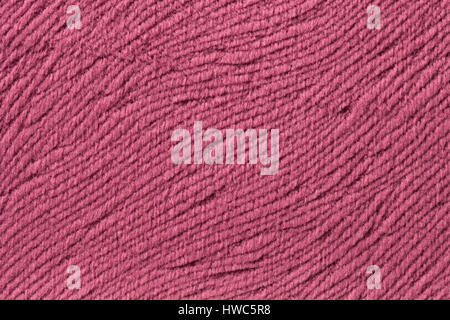 Dark pink background from a soft wool textile material closeup. Fabric with natural texture. Cloth backdrop. Stock Photo