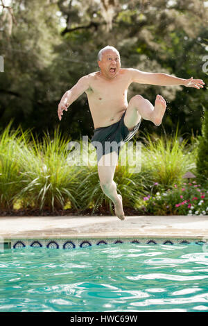 Senior playing in pool Stock Photo