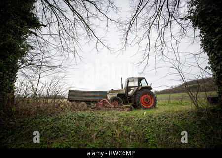 An old tractor in a field in Surrey , UK Stock Photo