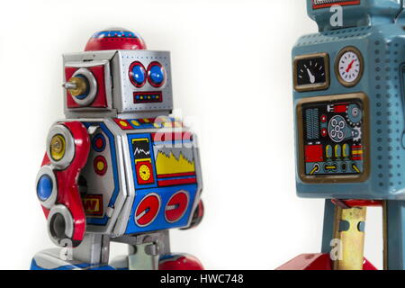Pair of vintage tin toy robots isolated on white background Stock Photo