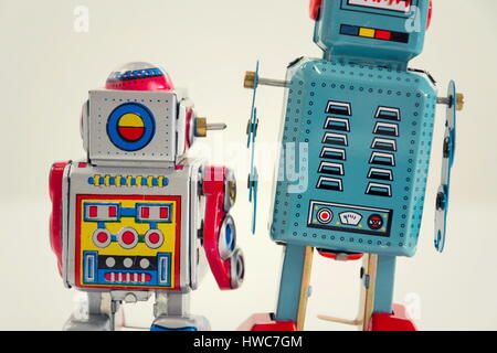 Filtered vintage tin toy robots isolated on white background Stock Photo