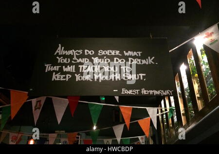 A signboard with witty message inside a Dublin pub - An Earnest Hemmingway quote Stock Photo