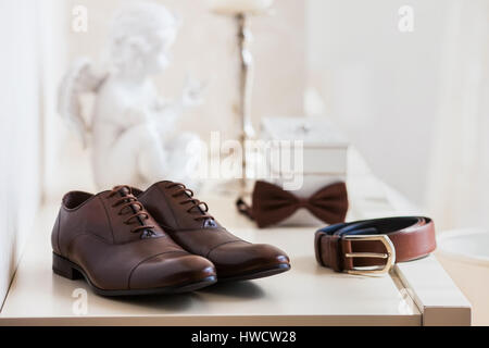Brown leather men's shoes with belt, bow-tie. Set groom accessories. Stock Photo