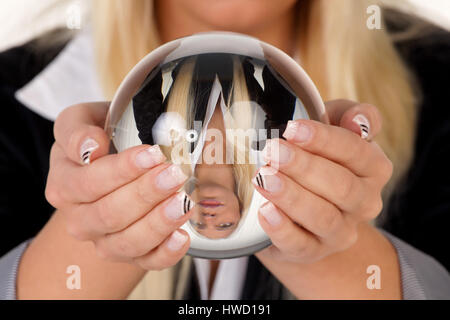 Young woman interprets the future from a crystal ball in her hands, Junge Frau deutet die Zukunft aus einer Kristallkugel in ihren H‰nden Stock Photo