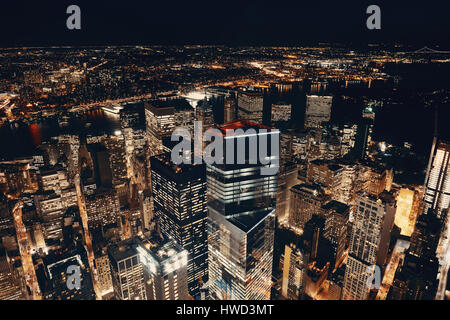 Rooftop night view of New York City downtown with urban skyscrapers ...