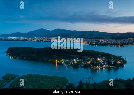 Greece, Epirus Region, Ioannina, elevated city view, Lake Pamvotis and Nisi Island, dusk Stock Photo