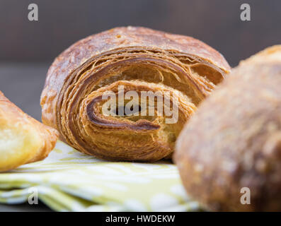 End of Chocolate Croissant freshly baked and sitting on napkin Stock Photo